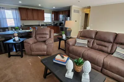 a living room with two couches and a kitchen at Pet Friendly Home with Fenced in Yard in Bethany