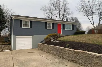 a blue house with a red door and a driveway at West Chester Mason Home Near Kings Island in Pisgah