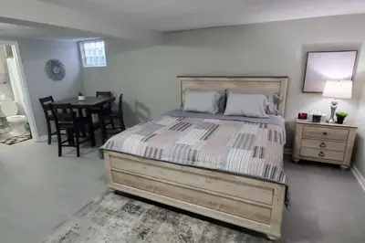 a bedroom with a large bed and a dining table at West Chester Mason Home Near Kings Island in Pisgah