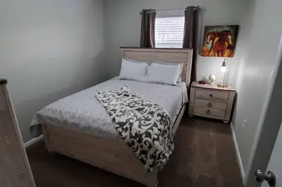 a bedroom with a bed with a black and white blanket at West Chester Mason Home Near Kings Island in Pisgah