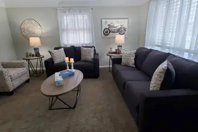 a living room with a blue couch and a table at West Chester Mason Home Near Kings Island in Pisgah