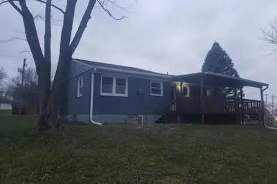 a blue house with a tree in the yard at West Chester Mason Home Near Kings Island in Pisgah