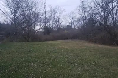 a field of grass with trees in the background at West Chester Mason Home Near Kings Island in Pisgah