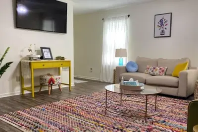 a living room with a couch and a table at Bailee's House in Monroe in Monroe