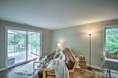 a living room with a couch and a window at Cozy Home on 17 Acres, 3 Miles to Downtown! in Fort Wayne