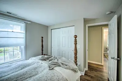 a bedroom with a bed and a large window at Cozy Home on 17 Acres, 3 Miles to Downtown! in Fort Wayne