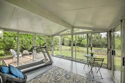 a living room with glass doors and a table and chairs at Cozy Home on 17 Acres, 3 Miles to Downtown! in Fort Wayne