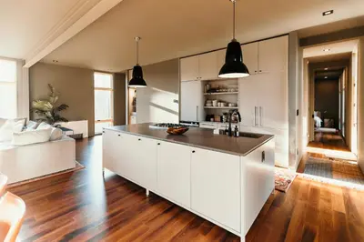 a kitchen with white cabinets and a large island at Idyll Reserve - Hocking Hills in South Bloomingville