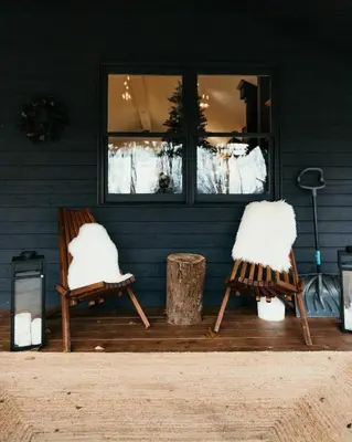 two chairs sitting on a deck in front of a house at Idyll Reserve - Hocking Hills in South Bloomingville