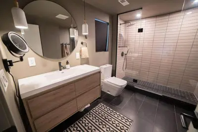 a bathroom with a sink and a toilet and a mirror at Idyll Reserve - Hocking Hills in South Bloomingville