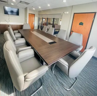 a conference room with a wooden table and chairs at Wingate by Wyndham Parkersburg-Vienna in Parkersburg