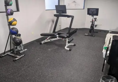 a room with three exercise equipment in a room at Wingate by Wyndham Parkersburg-Vienna in Parkersburg