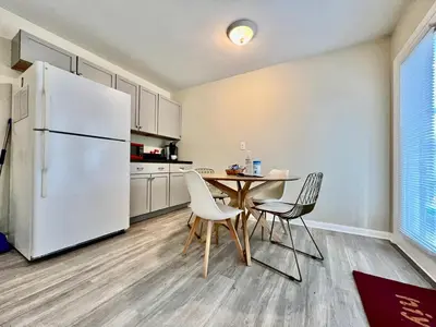 a kitchen with a table and a white refrigerator at Nice Place for the Budget Conscious in Middletown