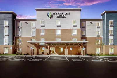 a rendering of the front of a building at WoodSpring Suites Dayton North in Dayton