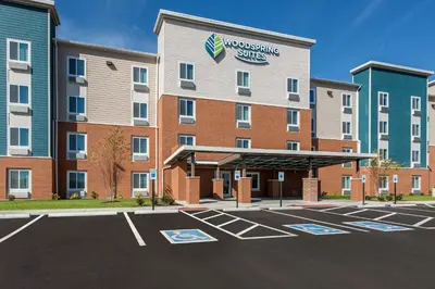 a hotel with a parking lot in front of it at WoodSpring Suites Dayton North in Dayton