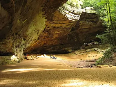 a group of people standing in a cave at Creekwood Chalet - Hocking Hills with Hot Tub and Near Hiking in South Bloomingville
