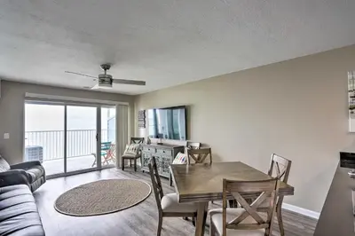 a living room with a dining room table with a view at Middle Bass Condo with Balcony, Lake Erie Views in Put-in-Bay