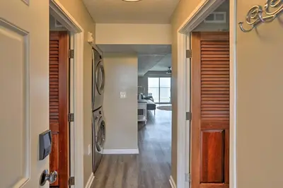 a hallway with a washer and dryer in a house at Middle Bass Condo with Balcony, Lake Erie Views in Put-in-Bay