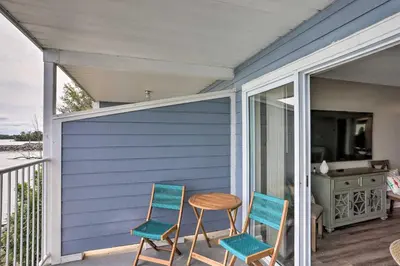 a porch with two chairs and a table on it at Middle Bass Condo with Balcony, Lake Erie Views in Put-in-Bay