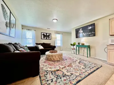 a living room with a couch and a table at Benji's House in Monroe