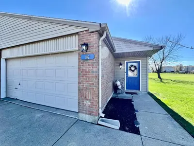 a house with a garage with a blue door at Benji's House in Monroe