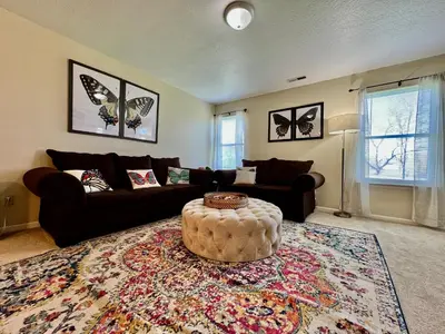 a living room with a couch and a table at Benji's House in Monroe