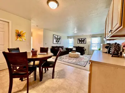 a kitchen and living room with a table and a couch at Benji's House in Monroe