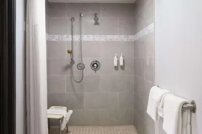a bathroom with a shower and a toilet at Days Inn by Wyndham Columbus Worthington in Columbus