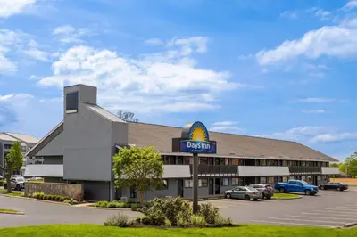 a hotel with a scientology sign in a parking lot at Days Inn by Wyndham Columbus Worthington in Columbus