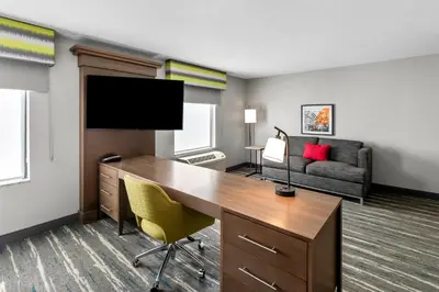 an office with a desk and a tv and a couch at Hampton Inn Middletown in Middletown