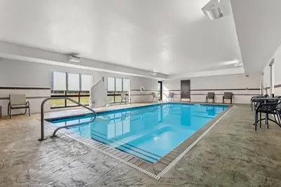 a large pool with blue water in a building at Hampton Inn Middletown in Middletown
