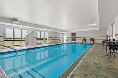 a pool with blue water in a building at Hampton Inn Middletown in Middletown