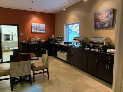 a kitchen with a counter and a table and chairs at Berlin Grande Hotel in Berlin