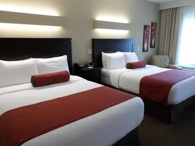 a hotel room with two beds with red and white sheets at Berlin Grande Hotel in Berlin