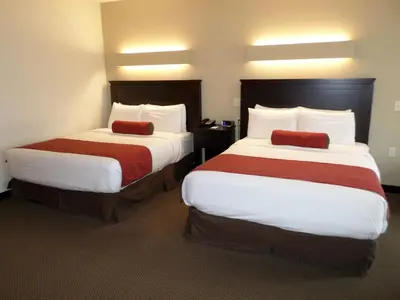 a hotel room with two beds with white and red sheets at Berlin Grande Hotel in Berlin