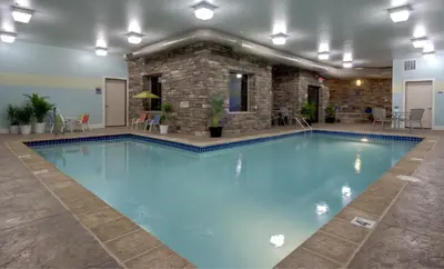 a large pool with blue water in a building at Berlin Grande Hotel in Berlin