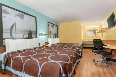 a hotel room with a bed and a desk at Super 8 by Wyndham Findlay in Findlay