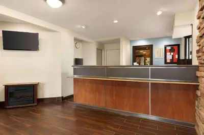 a bar in a waiting room with a fireplace at Super 8 by Wyndham Findlay in Findlay