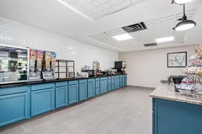 a restaurant with blue cabinets and a food counter at Country Inn & Suites by Radisson, Pickerington, OH in Pickerington