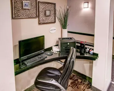 an office with a desk with a computer and a chair at Comfort Suites Pittsburgh Airport in Coraopolis