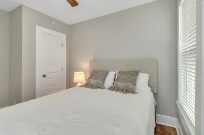 a bedroom with a white bed and a window at Recently Renovated Home in the Heart of Bellevue! home in Bellevue