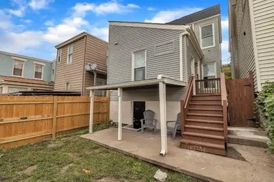 a house with a porch with a wooden fence at Recently Renovated Home in the Heart of Bellevue! home in Bellevue