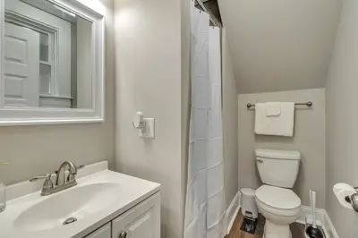 a bathroom with a sink and a toilet and a mirror at Recently Renovated Home in the Heart of Bellevue! home in Bellevue
