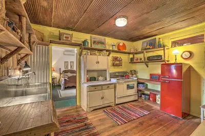 a kitchen with a red refrigerator in a room at Rustic Cabin in the Woods 2-Acre Fishing Pond! in Burlington