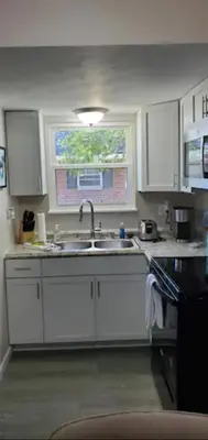 a kitchen with white cabinets and a sink and a window at A great newly renovated place to stay in Franklin in Franklin
