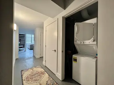 a kitchen with a stove and a refrigerator at Swanky loft at Historic Peters Cartridge Factory in Maineville