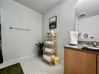 a bathroom with a sink and a shelf at Swanky loft at Historic Peters Cartridge Factory in Maineville