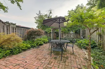 a patio with a table and an umbrella at Riverfront Studio with Private Patio and Garden! in Augusta