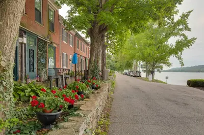 a street with flowers on the side of a building at Riverfront Studio with Private Patio and Garden! in Augusta