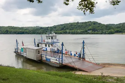 a boat is docked at a dock on a lake at Riverfront Studio with Private Patio and Garden! in Augusta